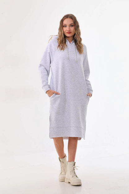 Woman wearing a light gray hoodie dress on a white background